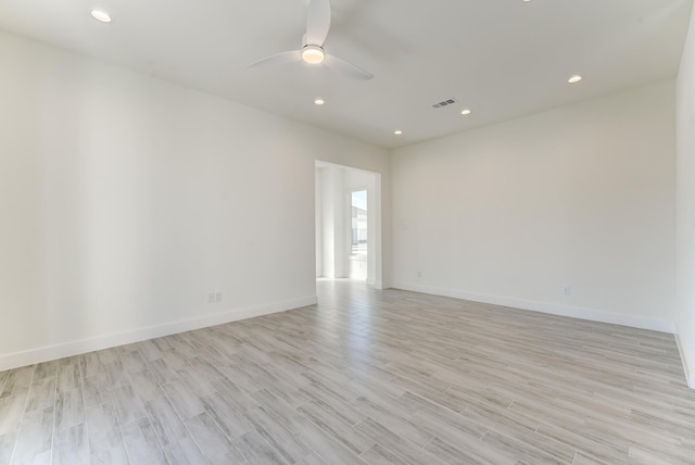 empty room featuring ceiling fan and light hardwood / wood-style flooring