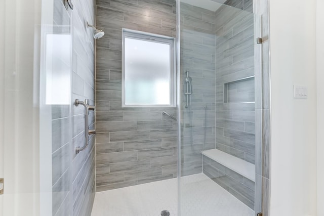 bathroom with a tile shower