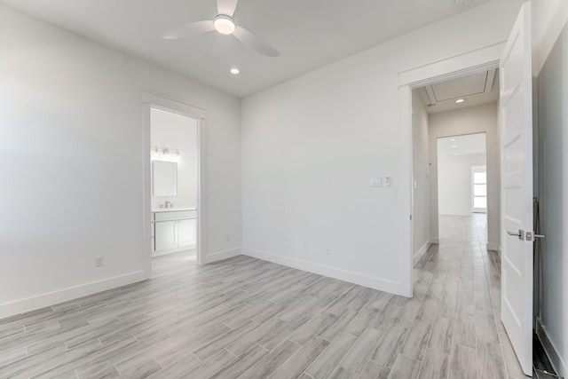 empty room with ceiling fan and light hardwood / wood-style floors