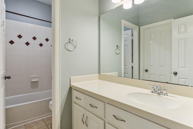 full bathroom with tile patterned flooring, vanity, toilet, and tiled shower / bath