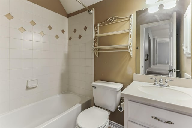 full bathroom featuring vanity, toilet, tiled shower / bath combo, and vaulted ceiling