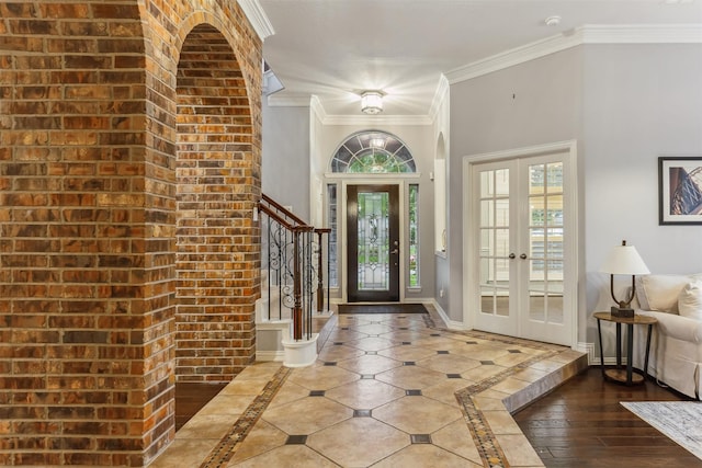 entryway featuring french doors, hardwood / wood-style floors, and ornamental molding