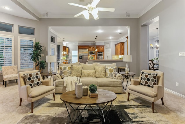 carpeted living room featuring ceiling fan with notable chandelier and ornamental molding