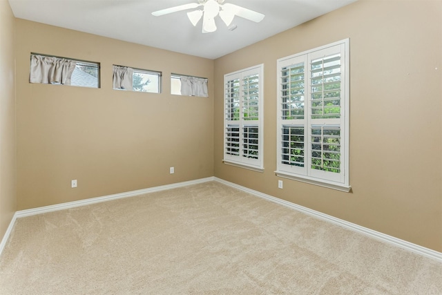 carpeted empty room featuring ceiling fan