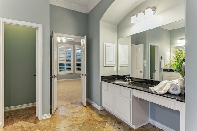 bathroom featuring crown molding, vanity, and ceiling fan