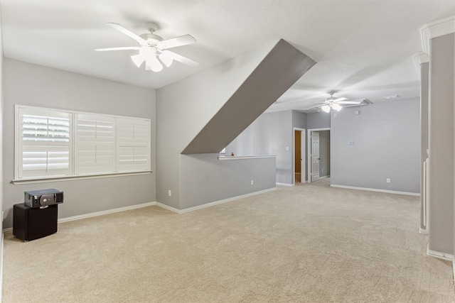 additional living space with light carpet and ceiling fan