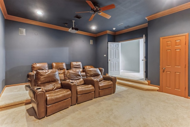 carpeted home theater room with ceiling fan and ornamental molding