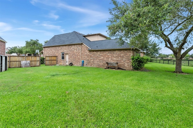 rear view of property featuring a lawn