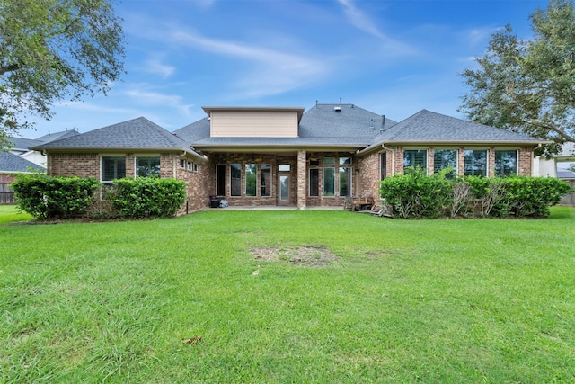 back of house with a lawn