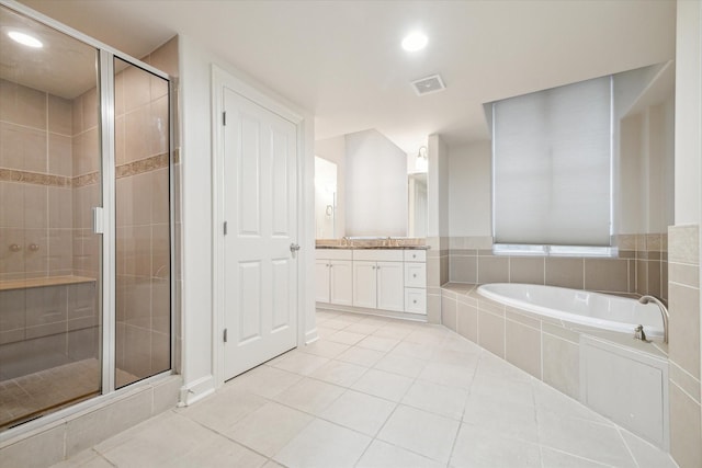 bathroom with tile patterned floors, vanity, and plus walk in shower