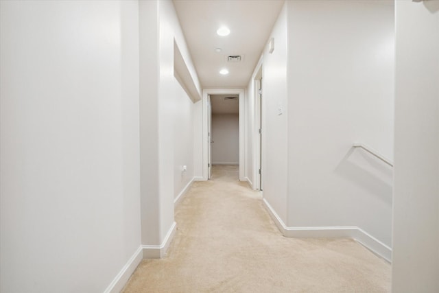 hall with light colored carpet