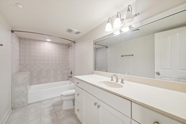 full bathroom featuring toilet, vanity, tiled shower / bath combo, and tile patterned floors