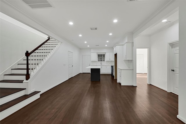 kitchen featuring a kitchen island, dark hardwood / wood-style flooring, backsplash, white cabinets, and ornamental molding