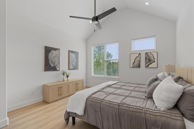 bedroom with light hardwood / wood-style floors, ceiling fan, and lofted ceiling