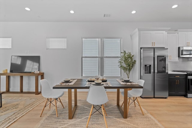 dining space with light hardwood / wood-style floors