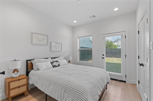 bedroom with access to outside and light hardwood / wood-style flooring