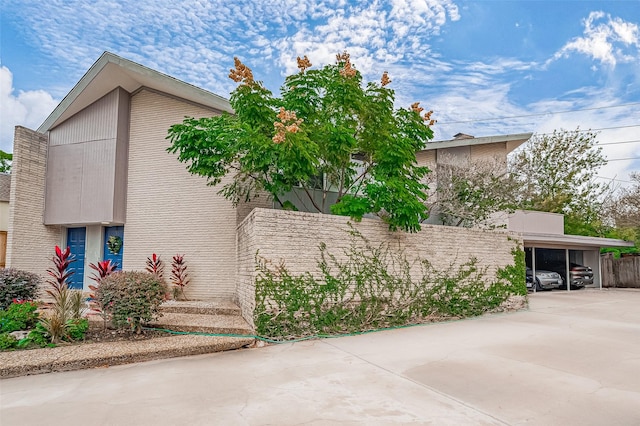 view of home's exterior featuring a carport