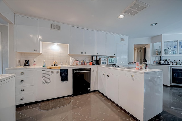 kitchen with white cabinetry, stainless steel appliances, wine cooler, decorative backsplash, and kitchen peninsula