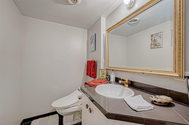 bathroom with vanity and toilet