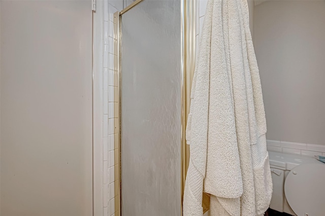 bathroom featuring a shower and toilet