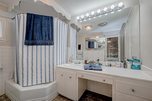 bathroom with crown molding, tile walls, vanity, and shower / bath combo with shower curtain