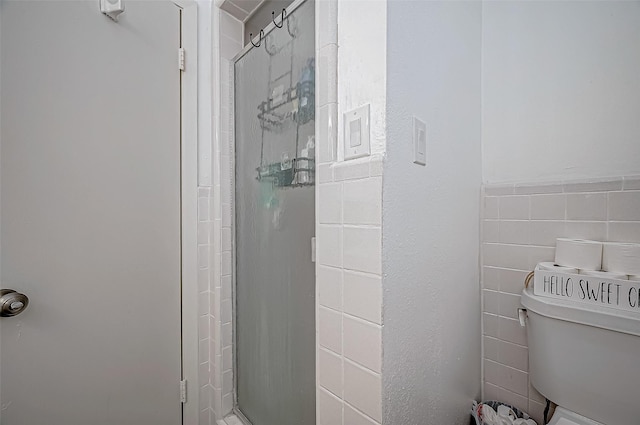 bathroom with toilet and walk in shower