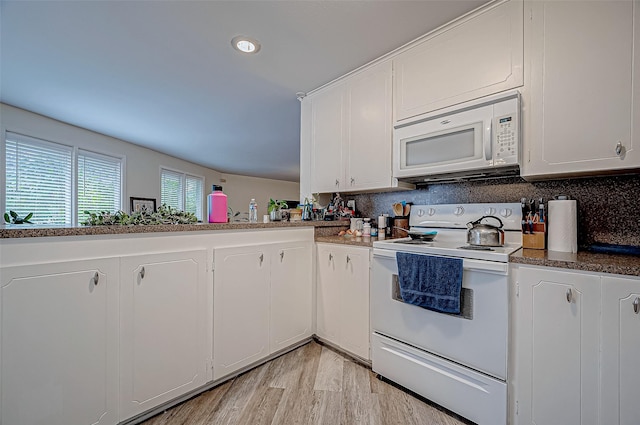 kitchen with white appliances, kitchen peninsula, light wood-type flooring, and white cabinets