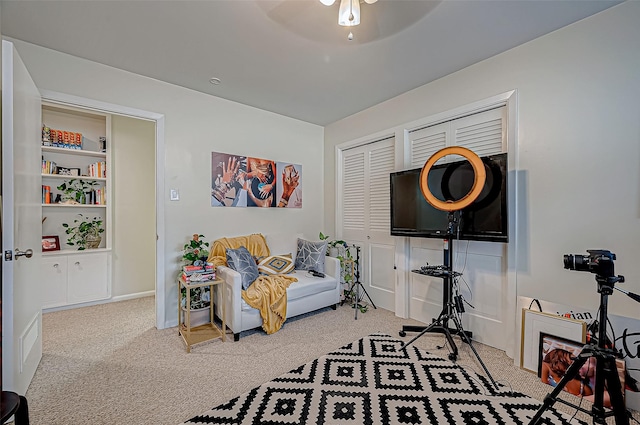 living area featuring ceiling fan and carpet floors