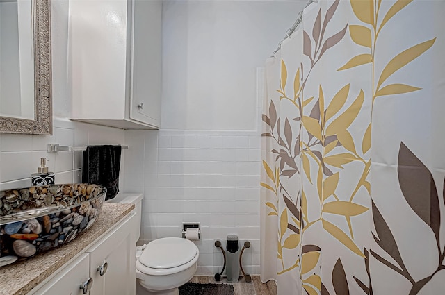 bathroom featuring vanity, wood-type flooring, and toilet