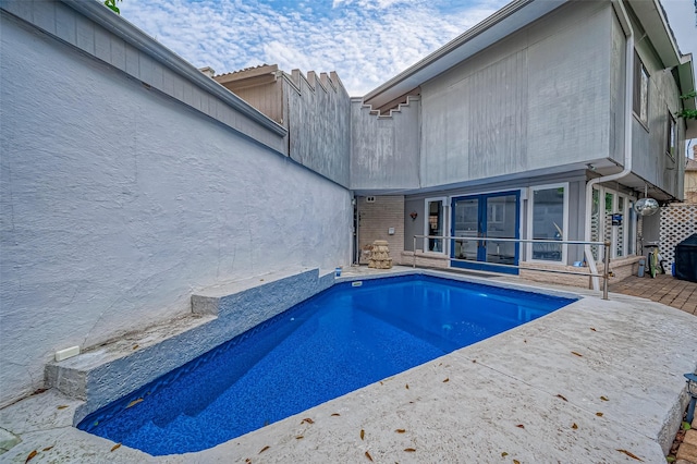 view of pool featuring a sunroom and a patio area