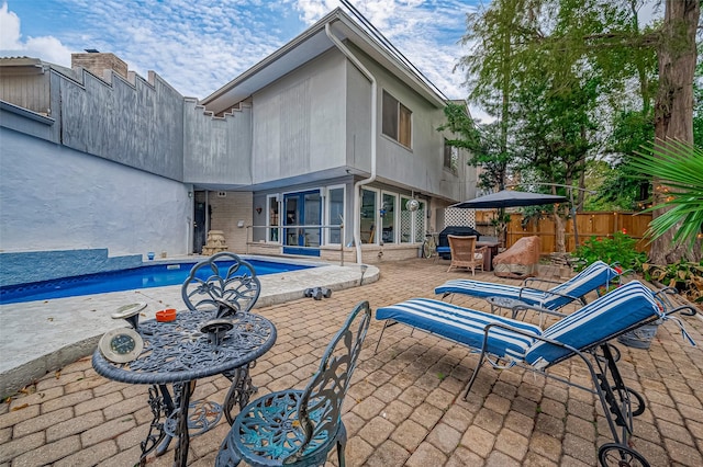 exterior space with a fenced in pool and a patio area