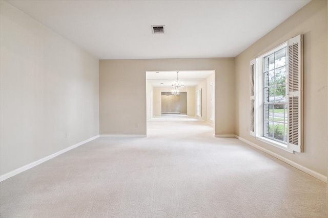 unfurnished living room with light colored carpet and an inviting chandelier