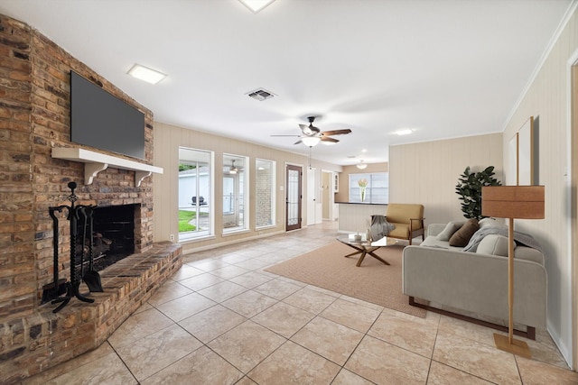 living room featuring light tile patterned floors, plenty of natural light, crown molding, and ceiling fan