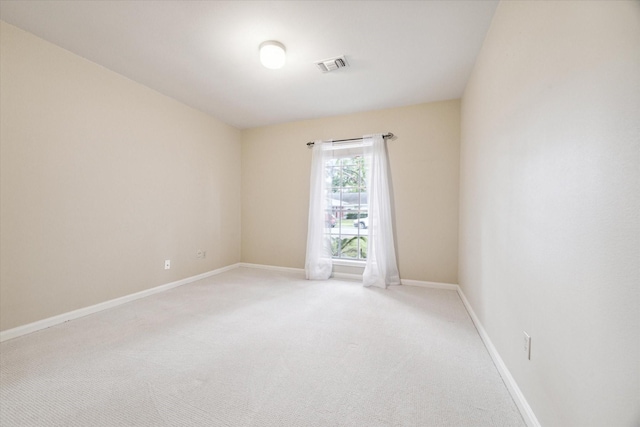 unfurnished room featuring light carpet