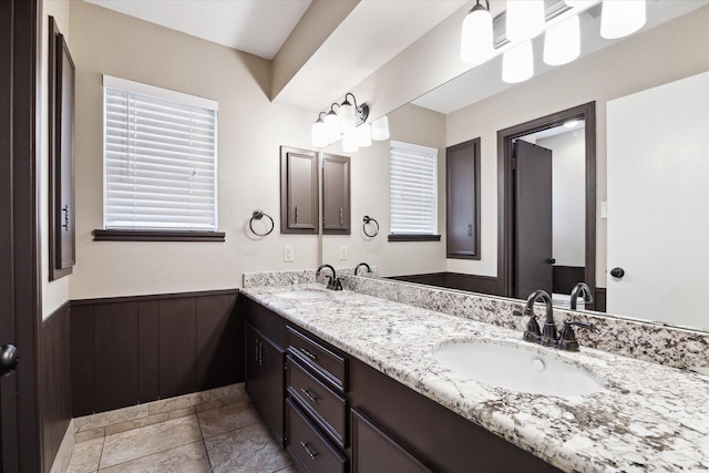 bathroom featuring wooden walls and vanity