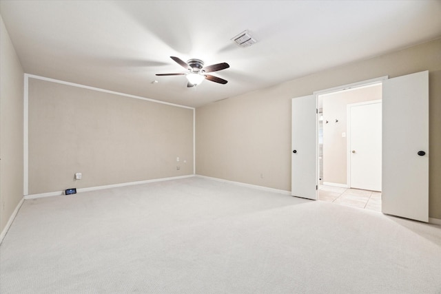 unfurnished room featuring ceiling fan and light carpet