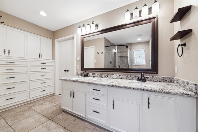 bathroom with vanity, tile patterned floors, and an enclosed shower