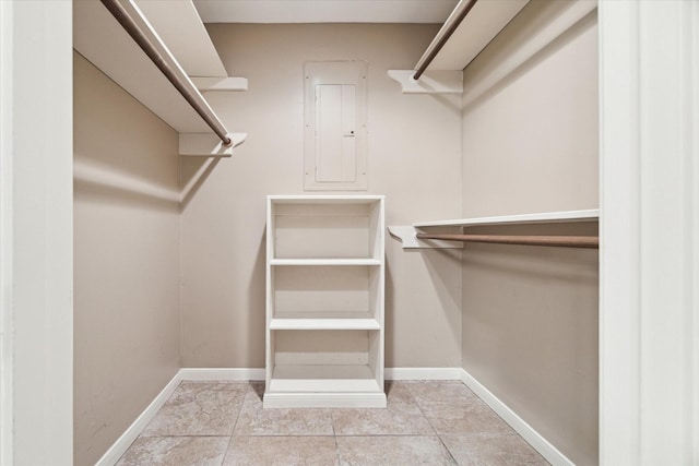 spacious closet with light tile patterned floors and electric panel