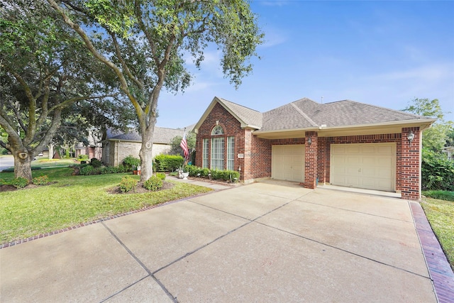 view of front of property with a front lawn and a garage