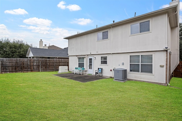 rear view of house with a yard, a patio, and cooling unit