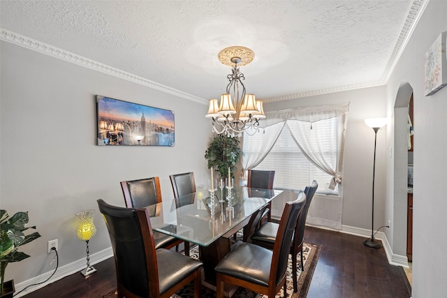 dining room featuring a textured ceiling, crown molding, and dark wood-type flooring