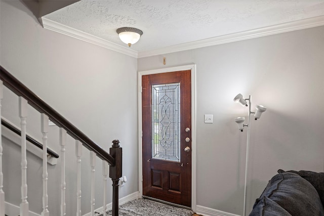 carpeted entrance foyer featuring crown molding and a textured ceiling