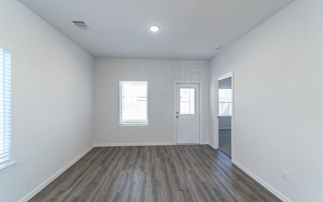 entrance foyer with visible vents, baseboards, and wood finished floors