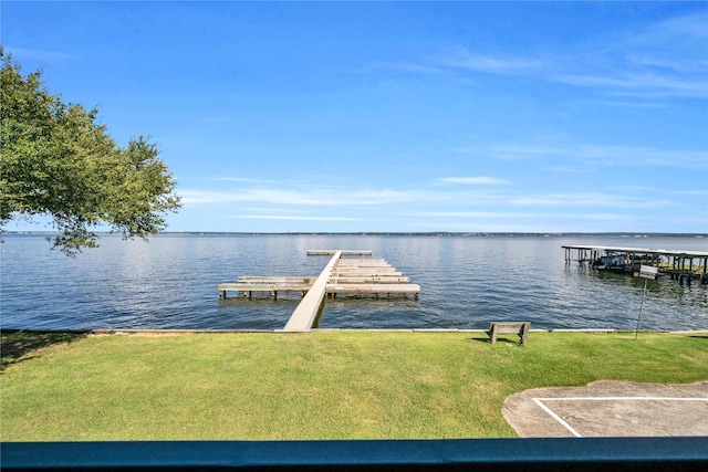 dock area with a water view and a lawn