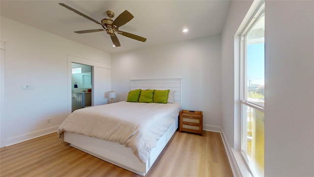 bedroom with ceiling fan and light hardwood / wood-style floors