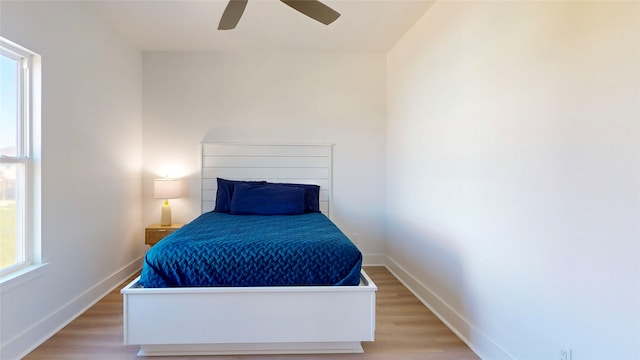 bedroom with ceiling fan and light hardwood / wood-style flooring