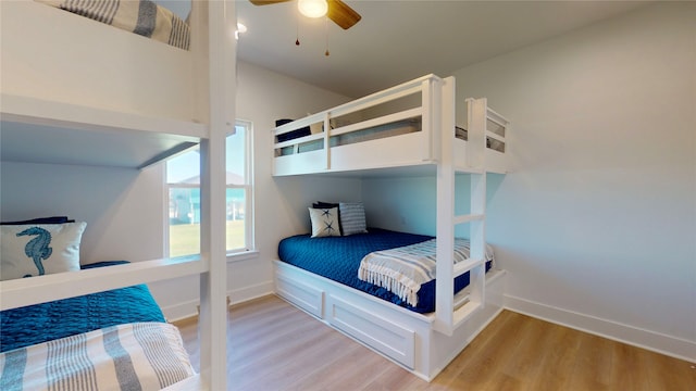 bedroom with light hardwood / wood-style floors and ceiling fan