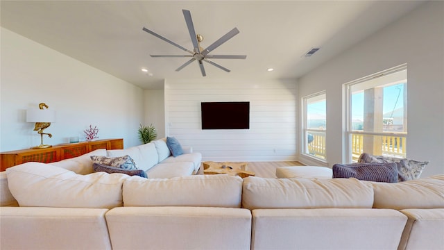 living room featuring ceiling fan and light wood-type flooring