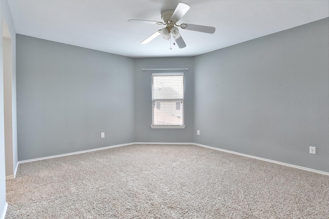 carpeted spare room with ceiling fan