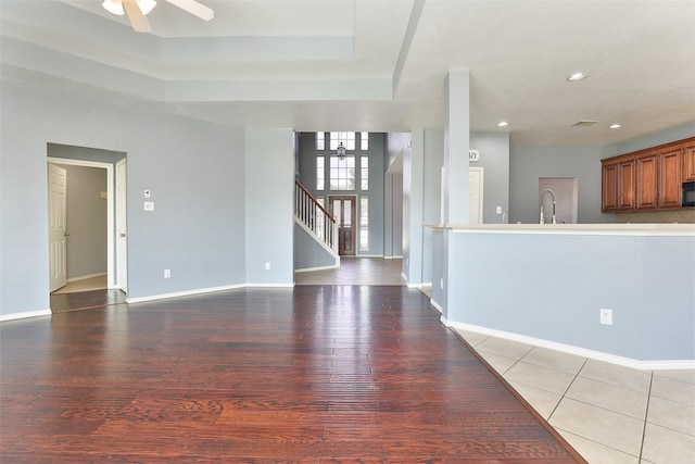 unfurnished living room with ceiling fan and light tile patterned flooring